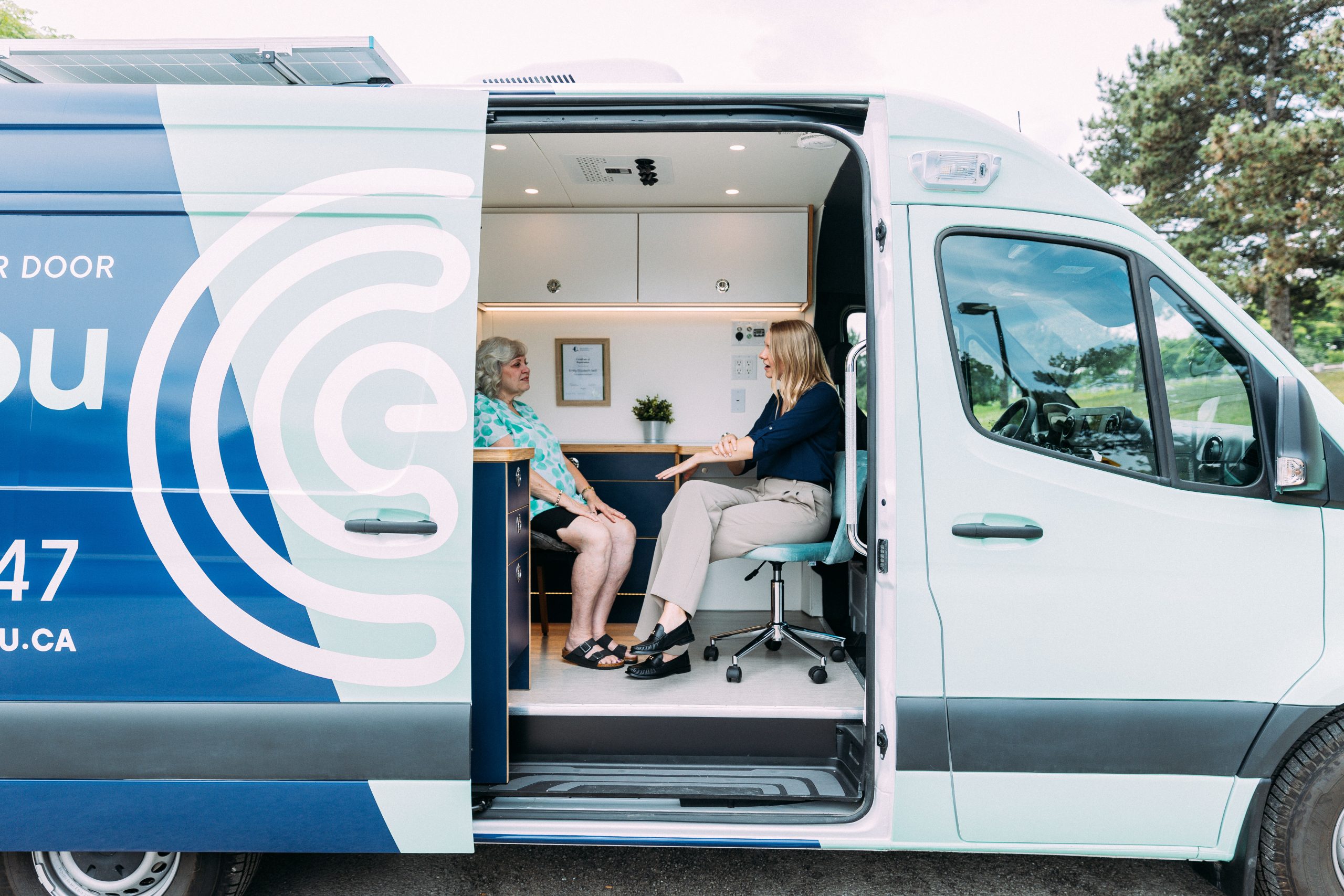 Audiologist, Emily Seitl, and her patient, discussing hearing loss in the Ears To You van